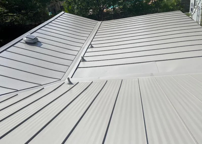 Solar attic fan installed on a metal roof for Roof Ventilation in Roxborough Park